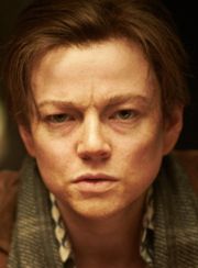 Sarah Snooke nel ruolo di John